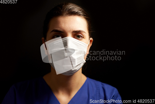 Image of female doctor or nurse in medical face mask