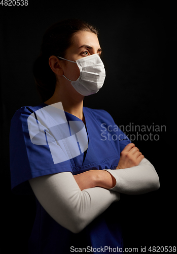 Image of female doctor or nurse in medical face mask