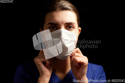 Image of female doctor or nurse in medical face mask