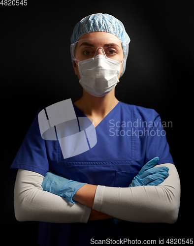 Image of female doctor or nurse in goggles and face mask