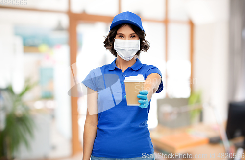 Image of saleswoman in face mask with coffee cup at office