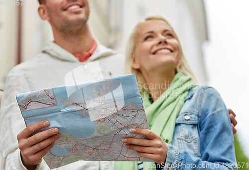 Image of close up of happy couple with map exploring city