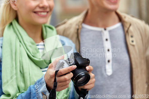 Image of close up of smiling couple with digital camera