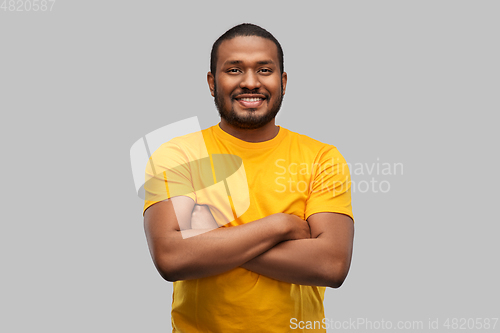 Image of smiling african american man with crossed arms