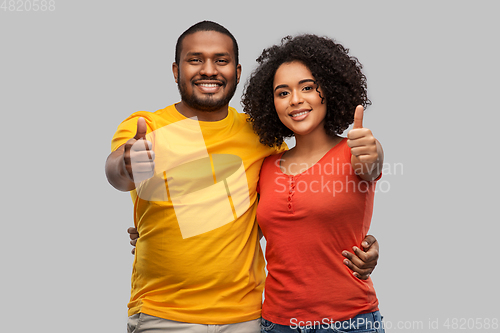 Image of happy african american couple showing thumbs up