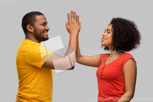 Image of happy african american couple making high five