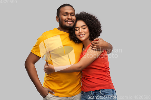 Image of happy african american couple hugging