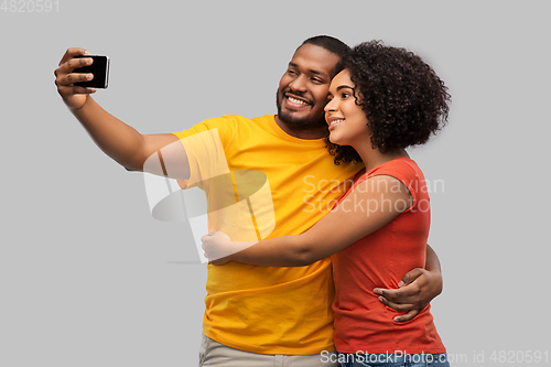 Image of african american couple taking selfie by cellphone