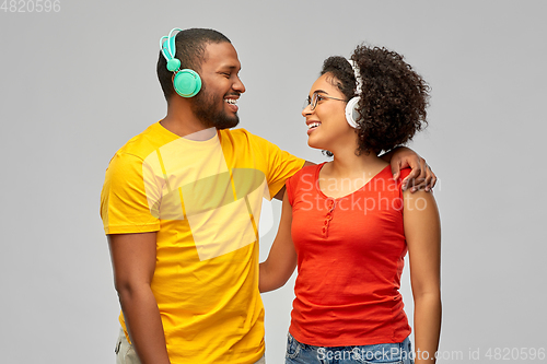Image of happy african american couple with headphones