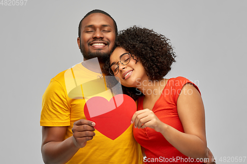 Image of happy african american couple holding red heart