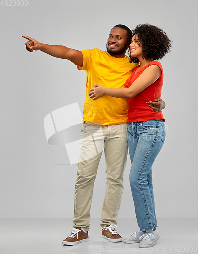 Image of african american couple pointing to something