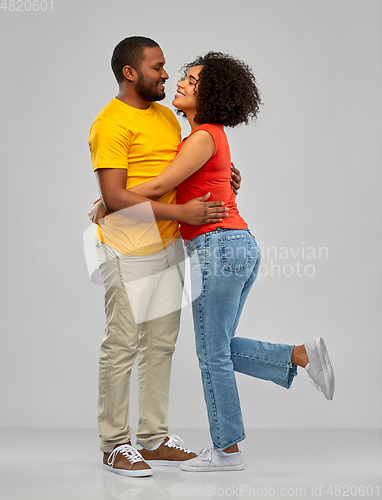 Image of happy african american couple hugging