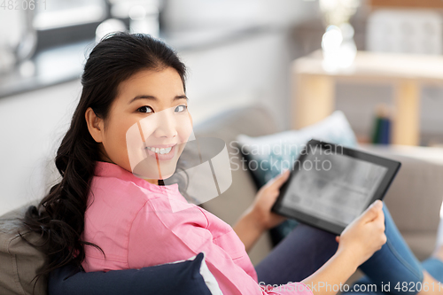 Image of asian young woman with tablet pc computer at home