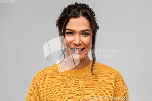 Image of happy smiling young woman with pierced nose