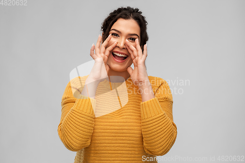 Image of happy woman with pierced nose calling