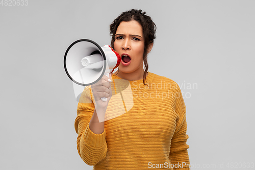 Image of angry young woman speaking to megaphone