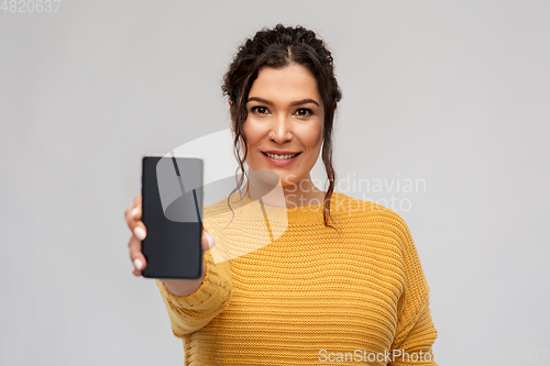 Image of happy woman showing smartphone