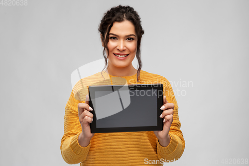 Image of happy young woman showing tablet pc computer