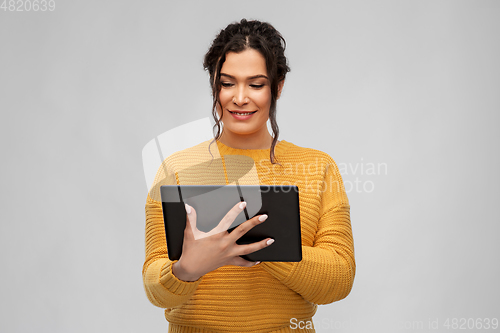 Image of happy young woman using tablet pc computer