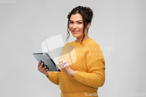 Image of happy young woman using tablet pc computer