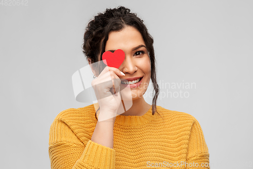 Image of happy smiling young woman with red heart