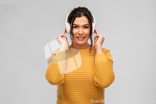 Image of happy woman in headphones listening to music