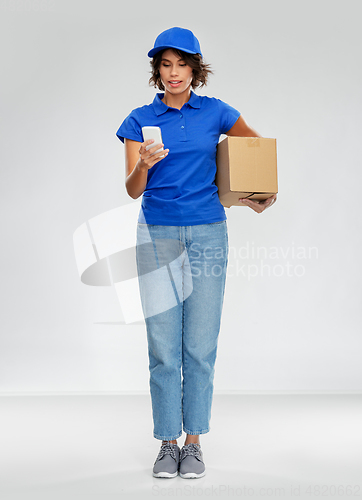 Image of delivery woman with smartphone and parcel box