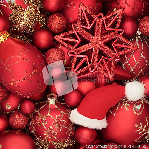 Image of Abstract Holly Santa Hat and Bauble Festive Background