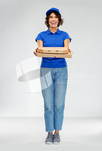 Image of happy smiling delivery woman with pizza boxes