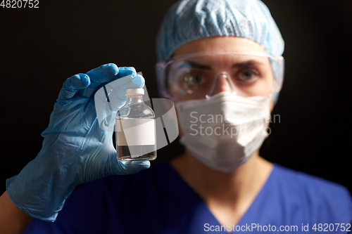 Image of close up of doctor's hand with bottle of medicine