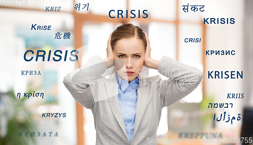 Image of stressed businesswoman with covered ears in crisis