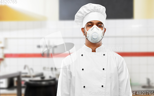 Image of male chef in respirator at restaurant kitchen