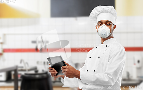 Image of chef in respirator with tablet pc at kitchen