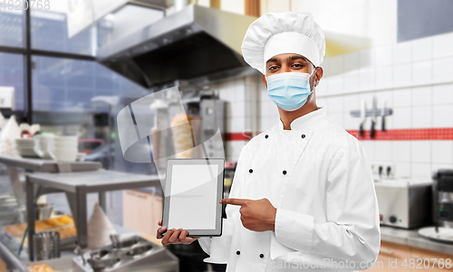 Image of male chef in face mask with tablet pc at kitchen