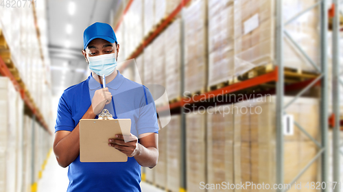 Image of delivery man in face protective mask at warehouse