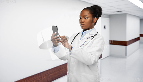 Image of african american female doctor with smartphone