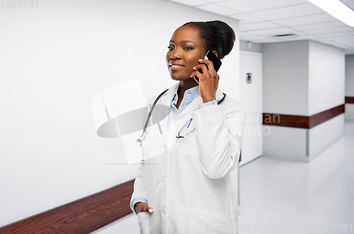 Image of african female doctor calling on smartphone