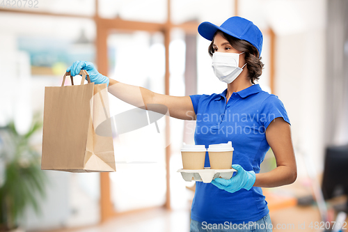 Image of delivery girl in mask with food at office