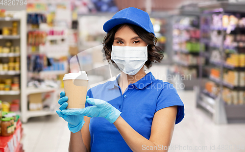 Image of saleswoman in mask with coffee cup at store