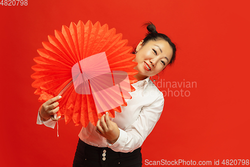 Image of Happy Chinese New Year. Asian young woman portrait isolated on red background