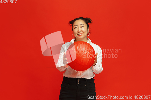 Image of Happy Chinese New Year. Asian young woman portrait isolated on red background