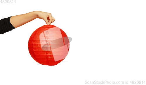 Image of Happy Chinese New Year. Female hand holding lantern on white background