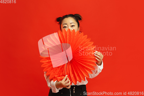 Image of Happy Chinese New Year. Asian young woman portrait isolated on red background