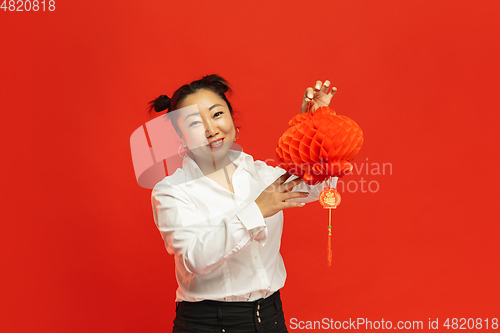 Image of Happy Chinese New Year. Asian young woman portrait isolated on red background