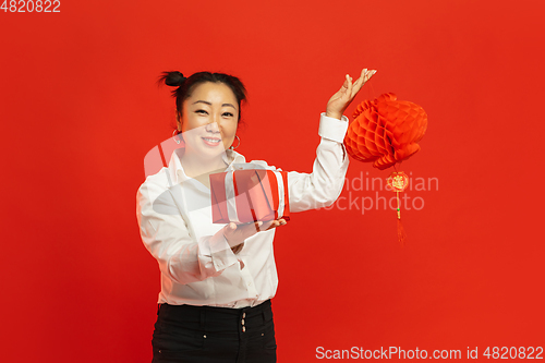 Image of Happy Chinese New Year. Asian young woman portrait isolated on red background