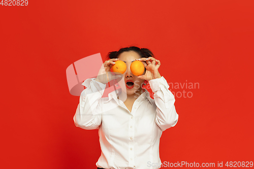 Image of Happy Chinese New Year. Asian young woman portrait isolated on red background