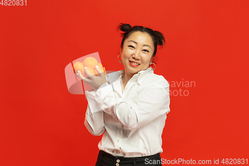 Image of Happy Chinese New Year. Asian young woman portrait isolated on red background