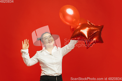 Image of Happy Chinese New Year. Asian young woman portrait isolated on red background