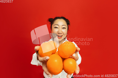 Image of Happy Chinese New Year. Asian young woman portrait isolated on red background