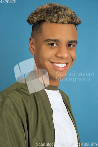 Image of African-american man\'s portrait isolated on blue studio background